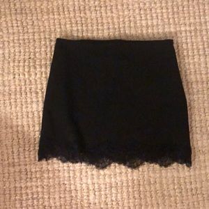 Fitted black mini skirt with lace bottom